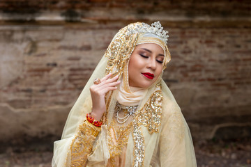 Fototapeta premium Portrait Of Young Bride Wearing wedding Hijab Standing and Looking Away