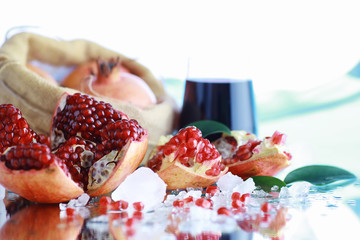 Ripe grains of pomegranate on the table. Pomegranate juice.