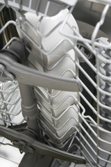 close-up of a lattice container, in a dishwasher, with clean mugs for coffee