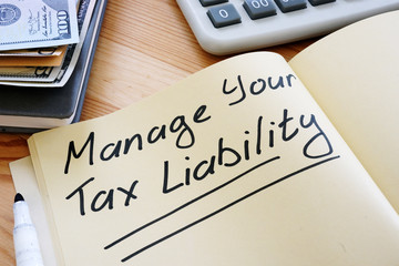 Business photo shows hand written text Manage Your Tax Liability