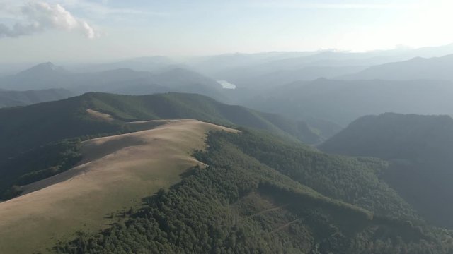Shot with drone over a mountain and a wild forest in Romania