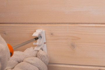 close-up of a screwdriver, tightens the fastening screws for laying polypropylene pipes