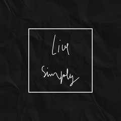 Live simply hand drawn lettering on black crumpled paper