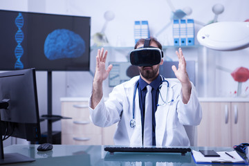 Caucasian doctor wearing a virtual reality headset looking in front of him