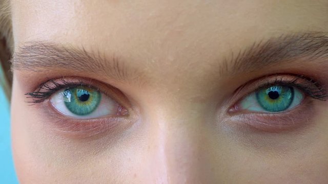 A close up portrait of beauty young beautiful woman's eyes, smiling looking at camera. 4 k. blue eyes of woman face, beautiful woman girl female portrait model, The girl's eye. opening her blue eyes