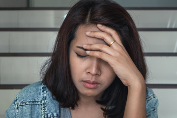 Close up sad woman sitting at staircase in apartment.Sad,depression concept. 