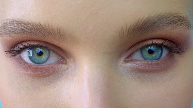 A close up portrait of beauty young beautiful woman's eyes, smiling looking at camera. 4 k. blue eyes of woman face, beautiful woman girl female portrait model, The girl's eye. opening her blue eyes
