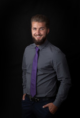 Portrait of an attractive bearded businessman. Isolated on a black background