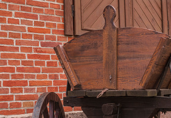 Wooden cart on a brick wall background