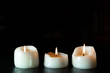 Fototapeta na wymiar mourning candles on black background