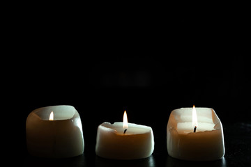 mourning candles on black background