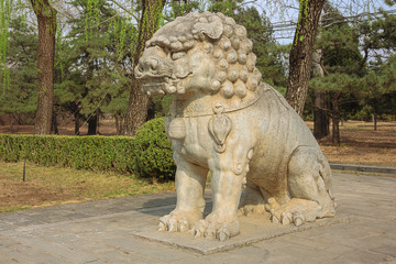 Statue of a sitting lion on the Sacred Road to the Ming Graves