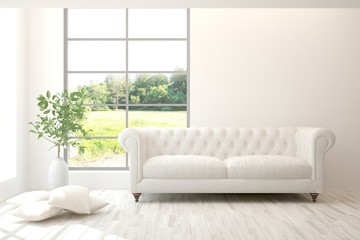 Stylish room in white color with sofa and summer landscape in window. Scandinavian interior design. 3D illustration