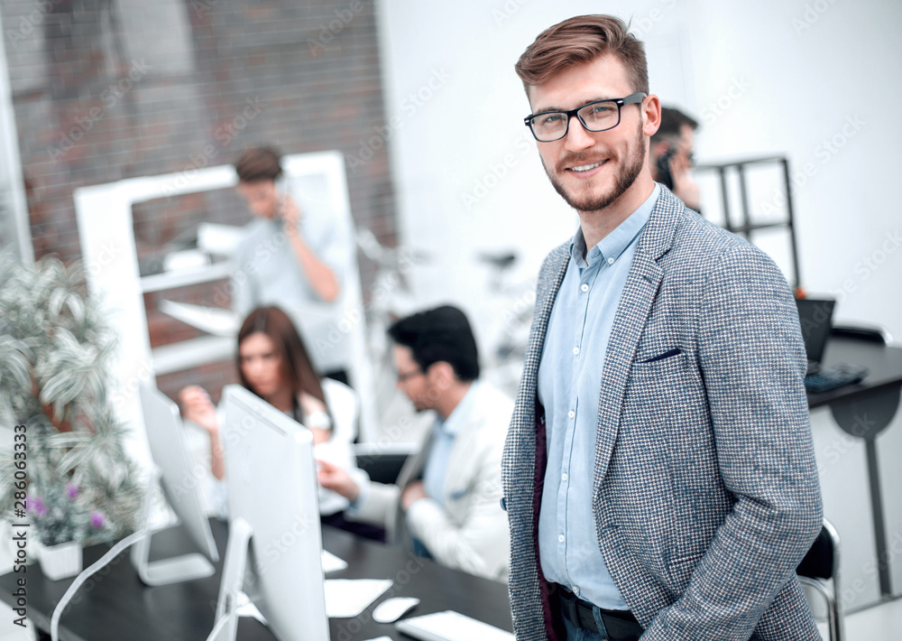 Wall mural modern young businessman on the background of the workplace