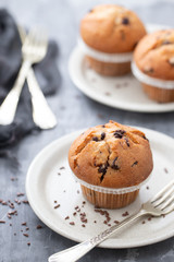 muffins with chocolate on white dish on ceramic background
