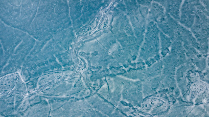 Fototapeta na wymiar Blue Ice surface of Frozen Lake from drone aerial view at Pangong Lake or Pangong Tso, Tso moriri – Nubra, India. Abstract concept of Cold winter, peaceful and freedom.