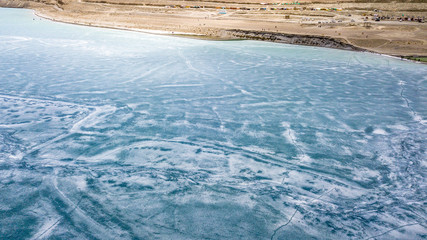 Blue Ice surface of Frozen Lake from drone aerial view at Pangong Lake or Pangong Tso, Tso moriri – Nubra, India. Abstract concept of Cold winter, peaceful and freedom.