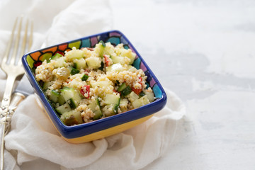 tabbouleh in small bowl on ceramic background