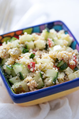 tabbouleh in small bowl on ceramic background