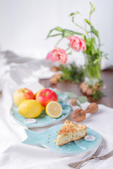apple pie on a blue plate. lemon with apples