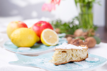 apple pie on a blue plate. lemon with apples