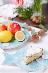 apple pie on a blue plate. lemon with apples