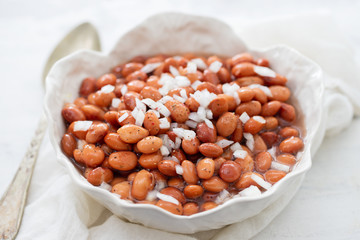 boiled beans with onion in white bowl