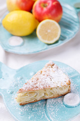 apple pie on a blue plate. lemon with apples