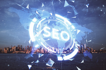 SEO hologram on city view with skyscrapers background double exposure. Search optimization concept.