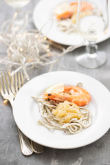 Traditional Spanish food. Gulas with oil and shrimp on white plate.
