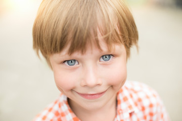 Photo of adorable young happy boy looking at camera
