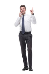 attentive young businessman talking on mobile phone. isolated on white