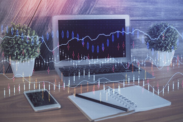 Double exposure of chart and financial info and work space with computer background. Concept of...