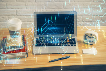 Double exposure of graph and financial info and work space with computer background. Concept of...