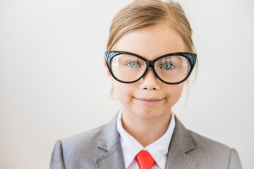 Happy business girl in big glasses and fashionable suit. Feminism, business woman concept