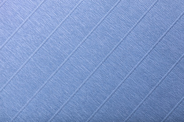 Fototapeta premium Textural of navy blue background of wavy corrugated paper, closeup.