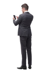 Obraz premium young businessman choosing a contact in his smartphone