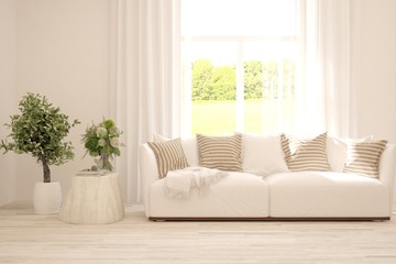Stylish room in white color with sofa and summer landscape in window. Scandinavian interior design. 3D illustration