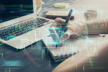 Forex chart displayed on woman's hand taking notes background. Concept of research. Multi exposure