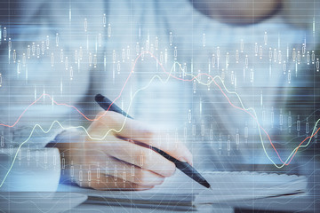 Forex chart displayed on woman's hand taking notes background. Concept of research. Multi exposure