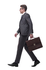 side view. confident businessman with leather briefcase stepping forward