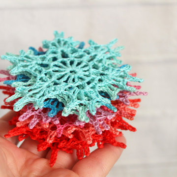 Crochet decorations, snowflakes for new year and Christmas of different colors.