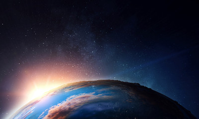 Earth with sunrise on blue space background