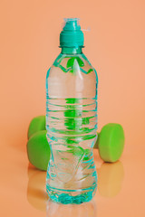 Plastic water bottles on a pastel beige background