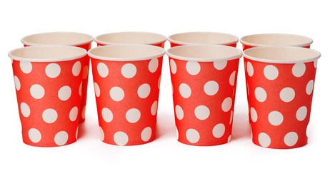 Group of cardboard disposable red dotted cups isolated
