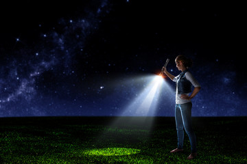 Fototapeta na wymiar Young woman holding a flashlight