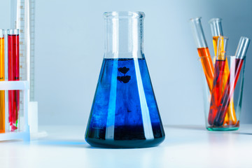 Laboratory flask glassware with reflections on table close up