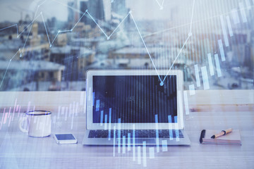 Financial chart drawing and table with computer on background. Double exposure. Concept of...
