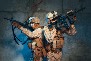 Fototapeta premium Two well equipped US army commandos armed with assault rifles. Studio shot