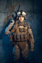 Fototapeta premium War, army, weapon concept. Private military contractor holding rifle